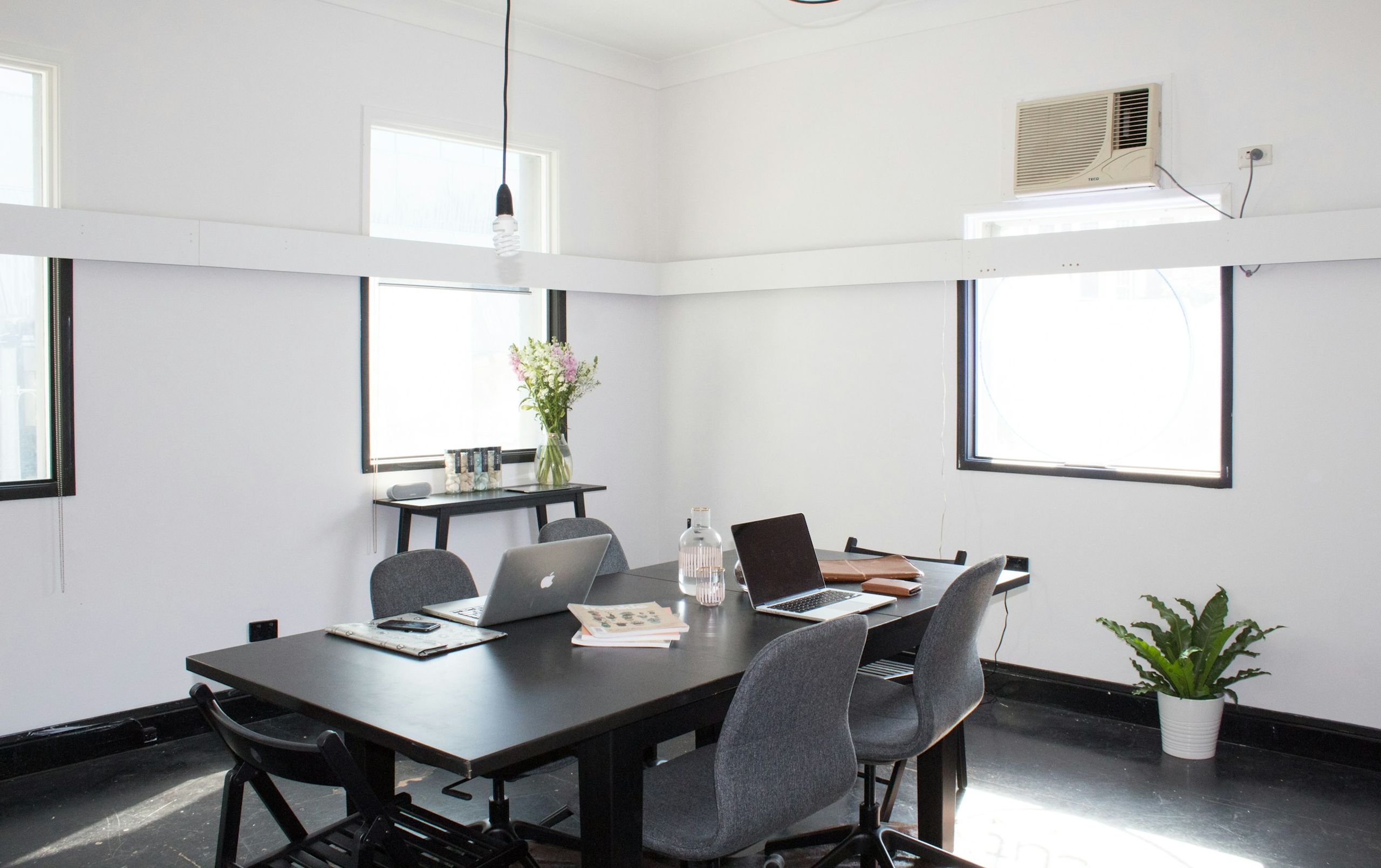 a modern office with laptops on the table